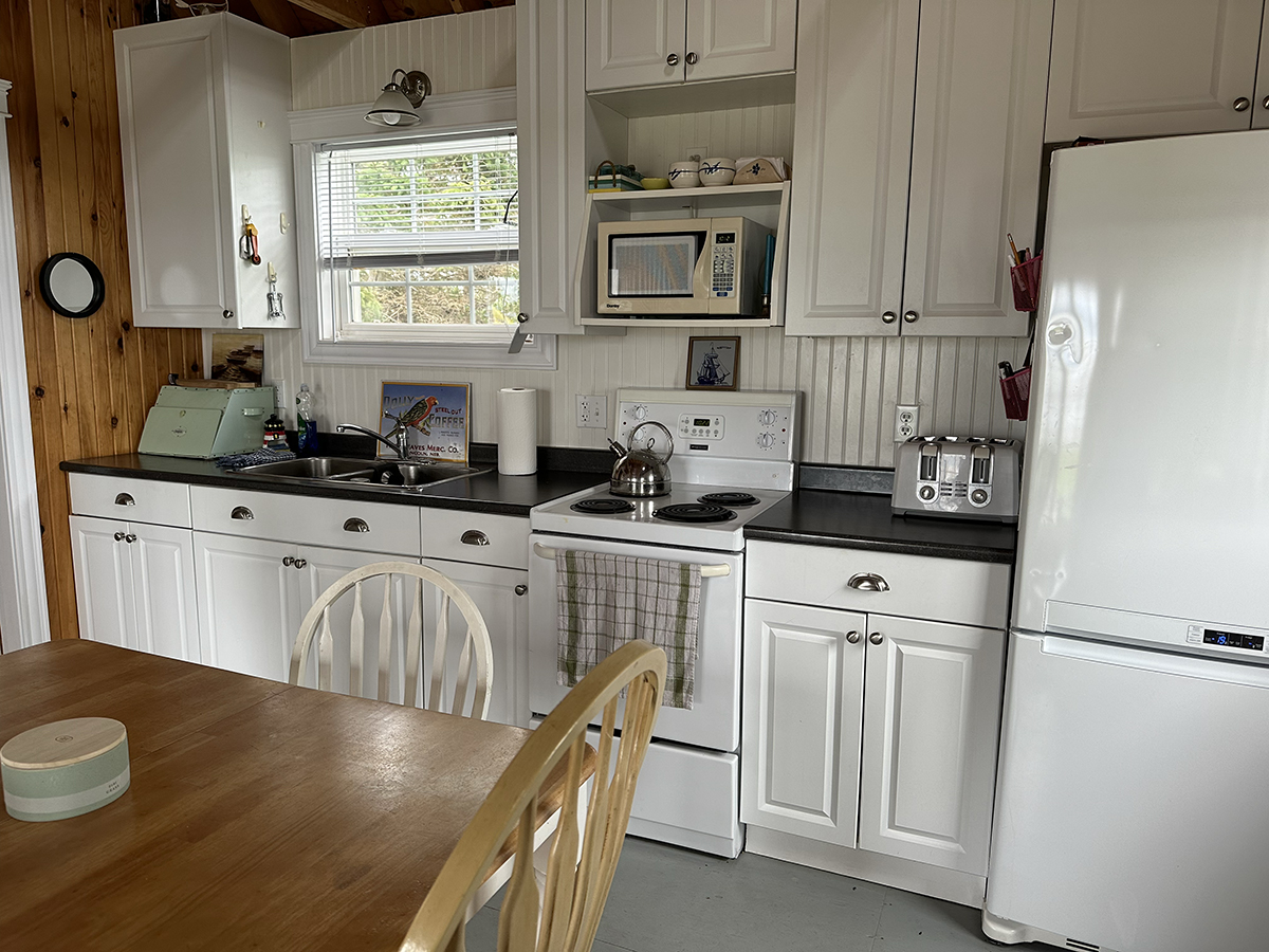 The kitchen includes a range, full-size refrigerator, microwave, four-slice toaster and kettle.