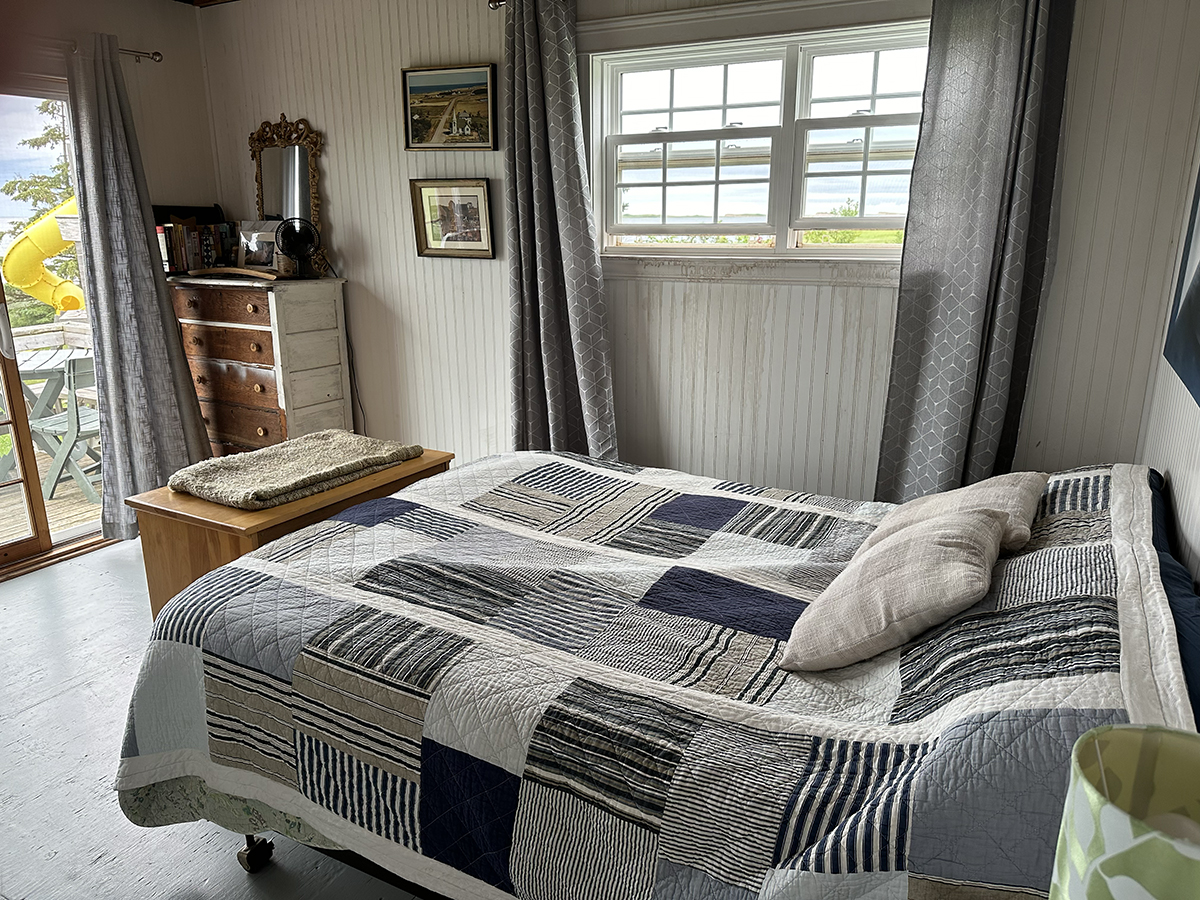 The master bedroom looks directly out on the water.